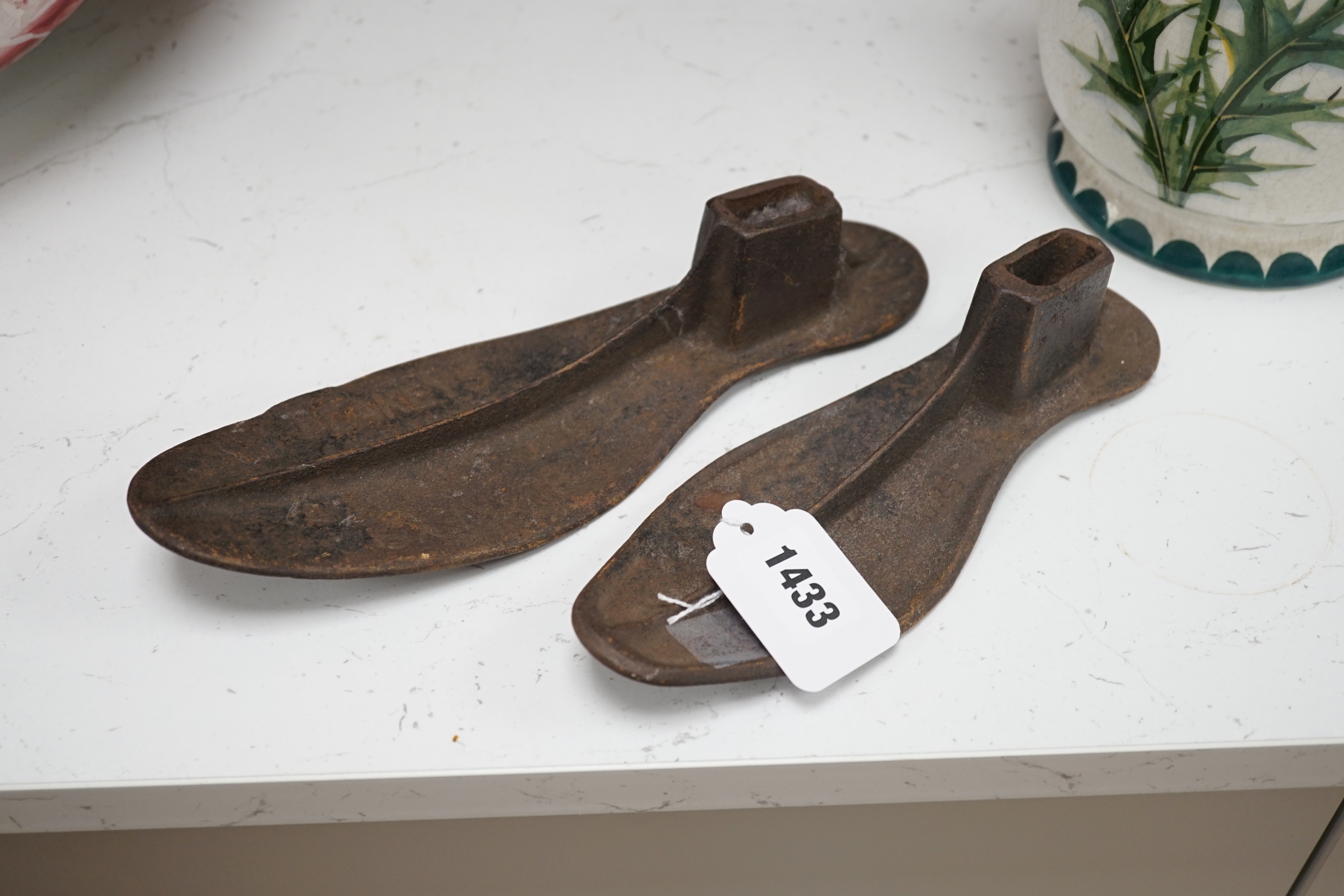 Six cast iron cobbler's forms and a door stop